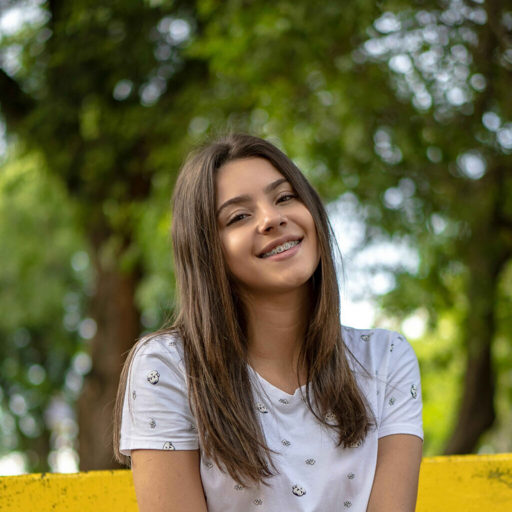 young girl wearing braces outside